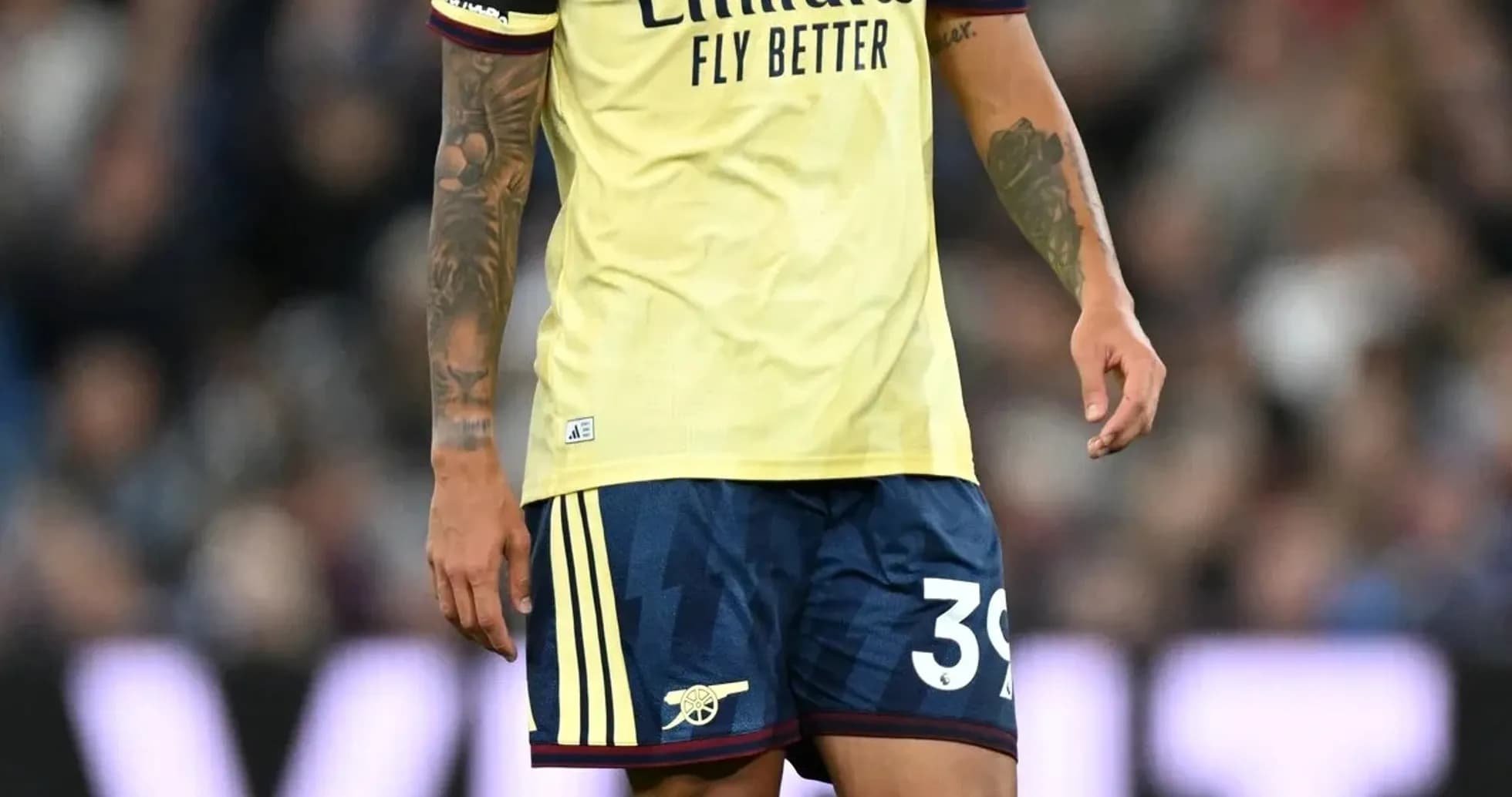 Player wearing Arsenal kit during match on field Player wearing Arsenal kit during match on field