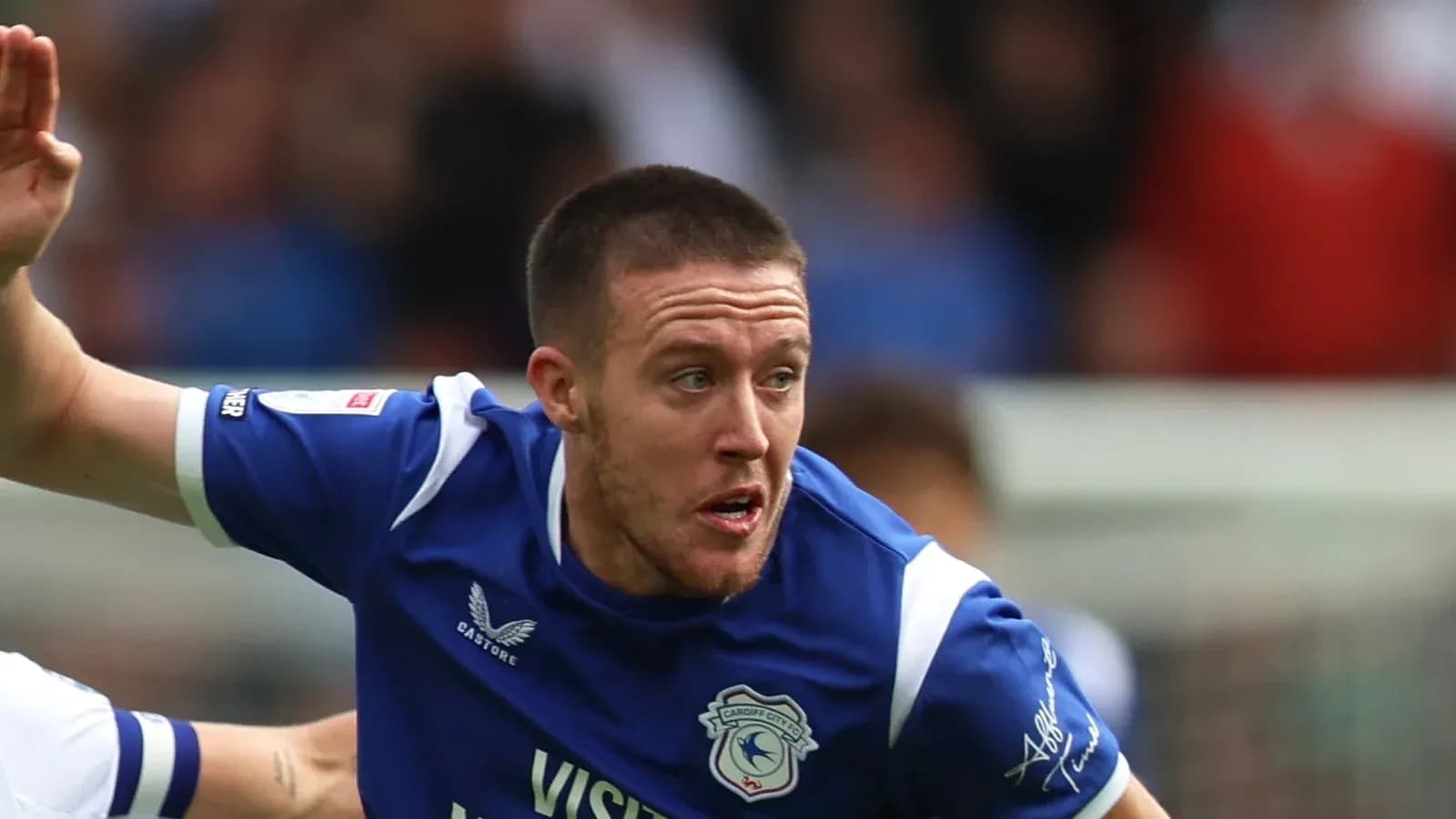 Player running during a football match for Cardiff City Player running during a football match for Cardiff City
