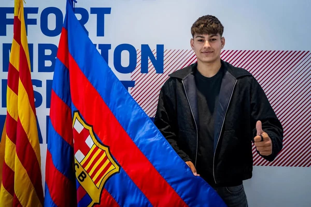 Young player holding FC Barcelona flag and smiling Young player holding FC Barcelona flag and smiling