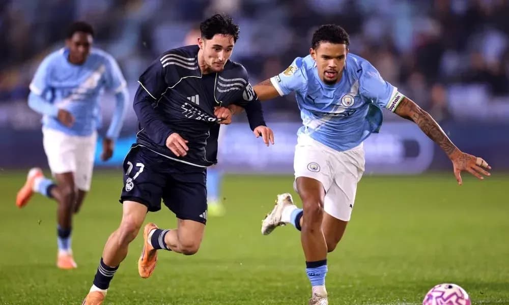 Player from Real Madrid sprinting past Manchester City opponent Player from Real Madrid sprinting past Manchester City opponent