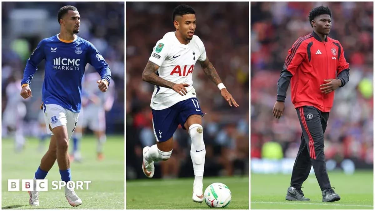 Three football players in team kits on the pitch Three football players in team kits on the pitch