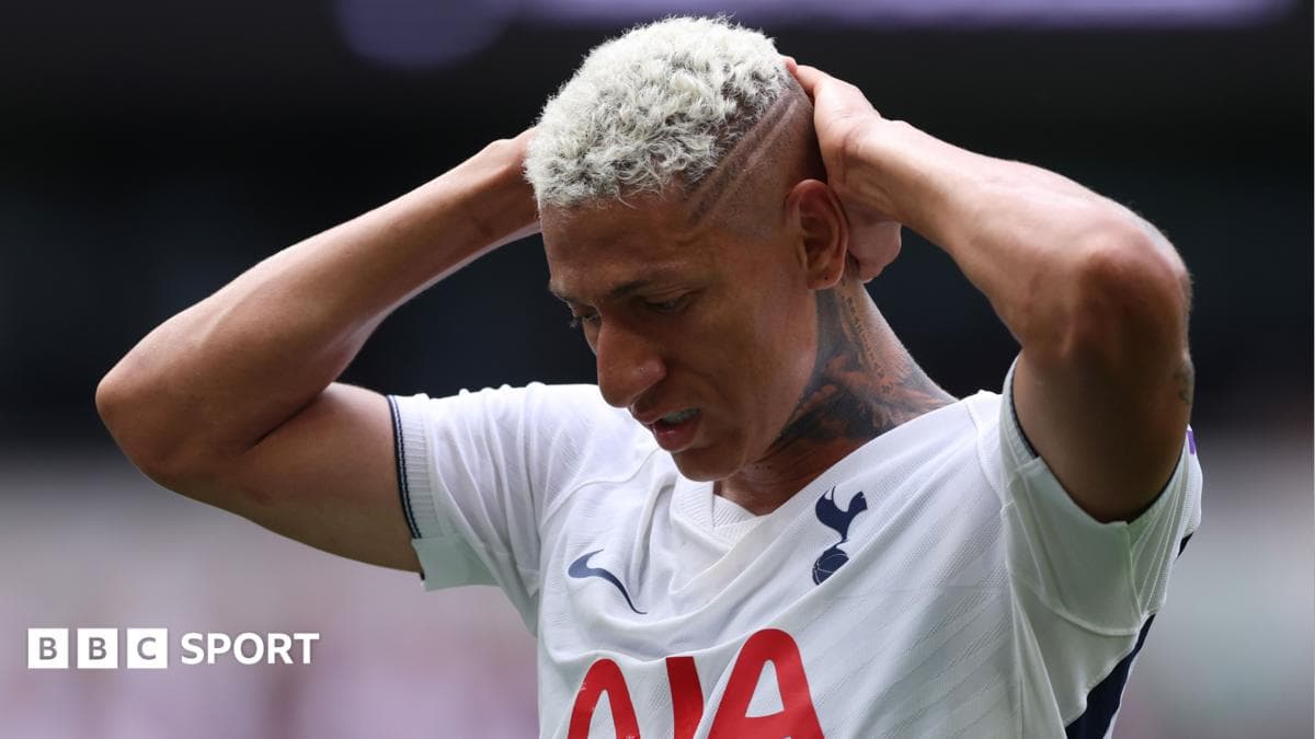 Player holding head in frustration on the pitch Player holding head in frustration on the pitch