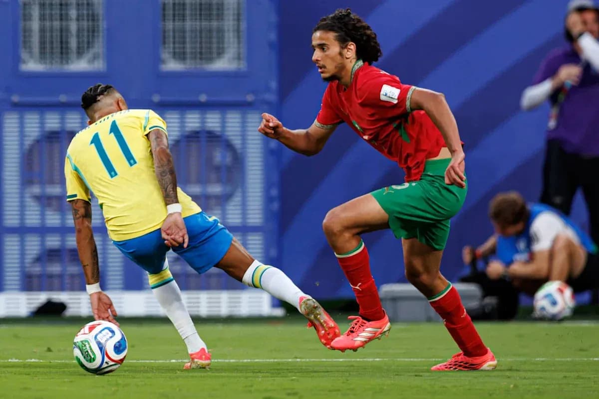 Brazilian player dribbling past Moroccan defender on pitch Brazilian player dribbling past Moroccan defender on pitch