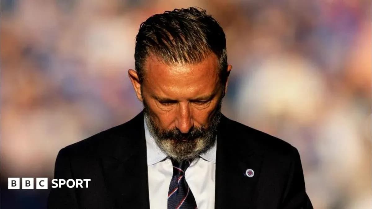 Coach with head bowed during press conference Coach with head bowed during press conference