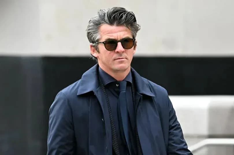Man in sunglasses walking outdoors in formal attire Man in sunglasses walking outdoors in formal attire