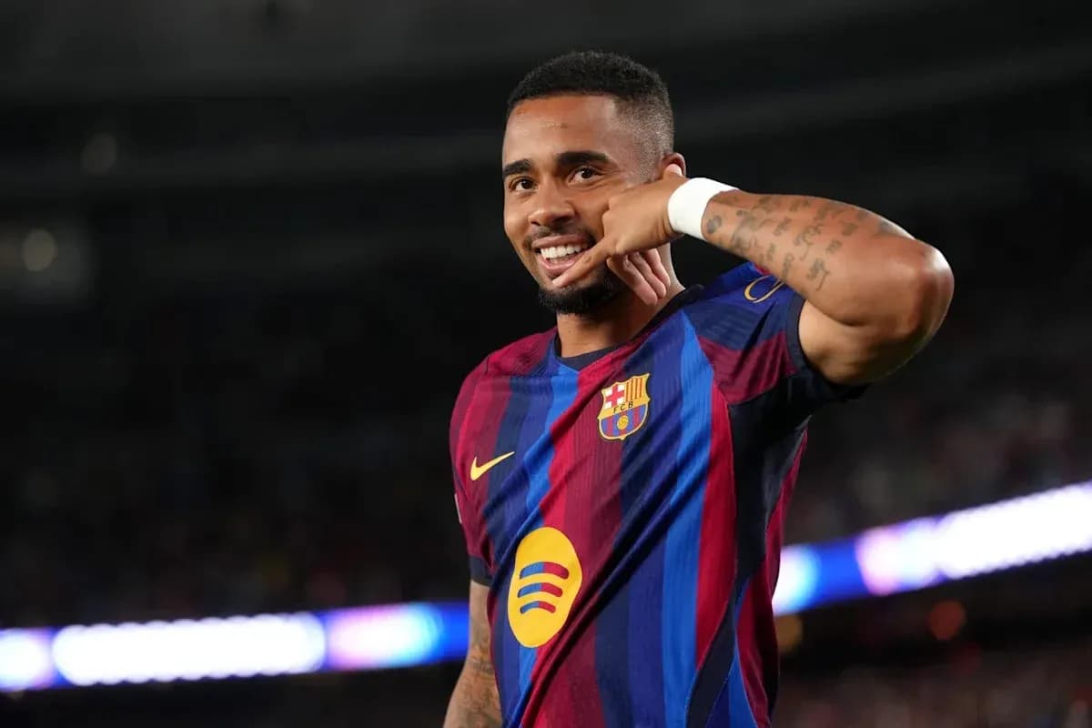 Player celebrating with a phone gesture on pitch Player celebrating with a phone gesture on pitch
