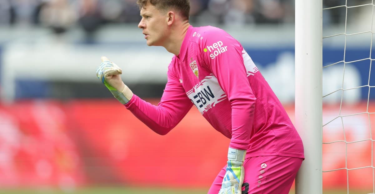 Goalkeeper in pink uniform directing teammates during match Goalkeeper in pink uniform directing teammates during match