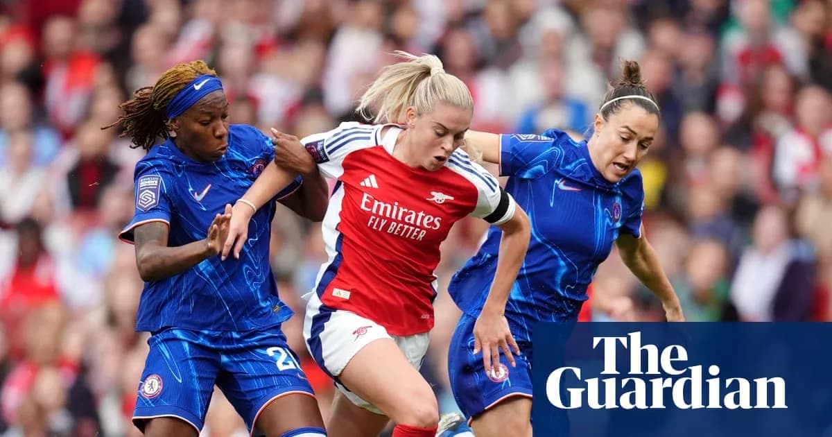 Two players challenging an Arsenal player for the ball Two players challenging an Arsenal player for the ball