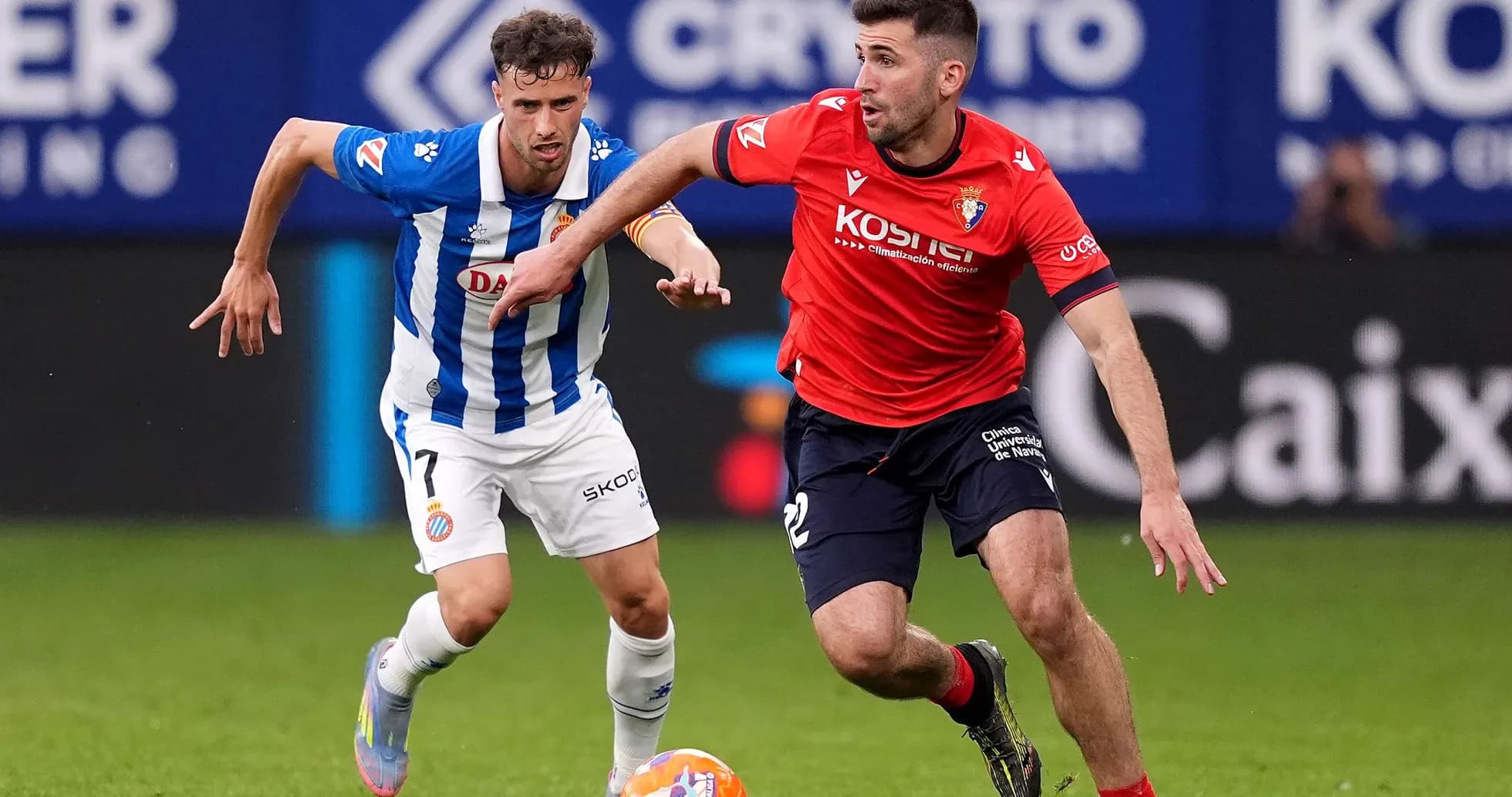 Osasuna player chasing Espanyol opponent with ball Osasuna player chasing Espanyol opponent with ball