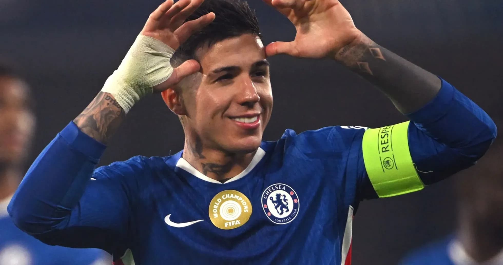 Player celebrating with hands raised in Chelsea kit Player celebrating with hands raised in Chelsea kit