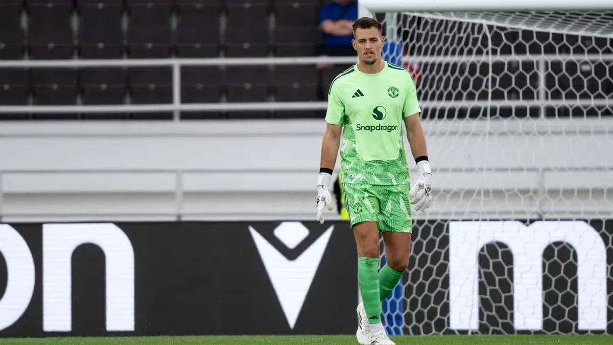 Goalkeeper in green kit standing near goalpost Goalkeeper in green kit standing near goalpost