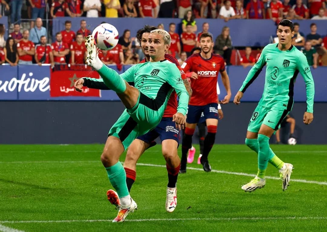 Atletico Madrid player attempting a bicycle kick Atletico Madrid player attempting a bicycle kick
