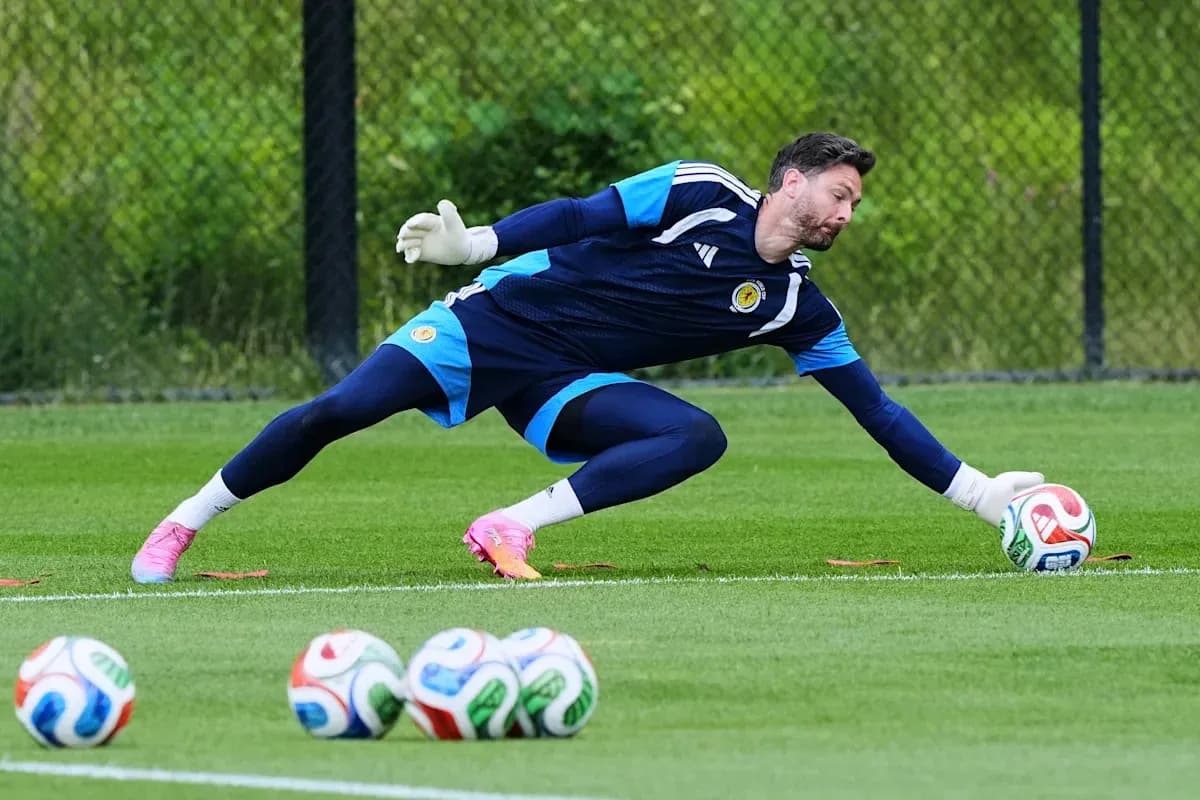Goalkeeper diving to catch ball during training session Goalkeeper diving to catch ball during training session