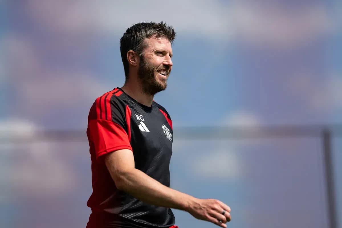 Coach walking on training pitch with Manchester United kit Coach walking on training pitch with Manchester United kit